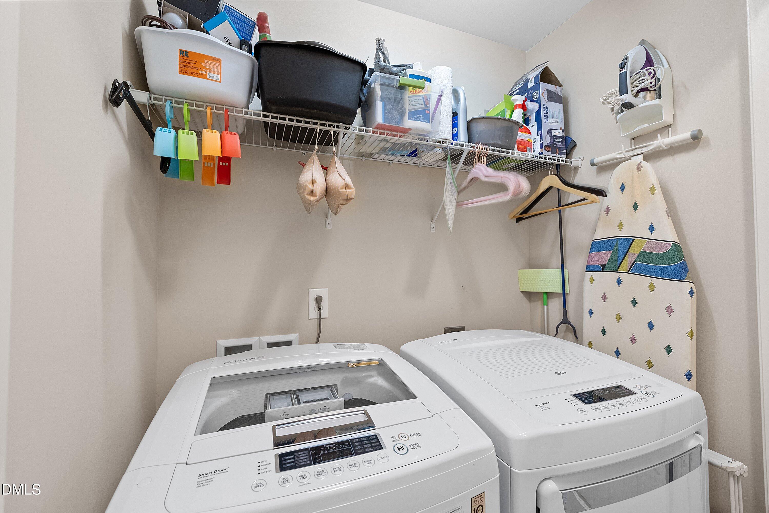 1093 Renewal Place Raleigh, NC 27603 - Photo 22 of 45 a utility room with dryer washer and a view of living room