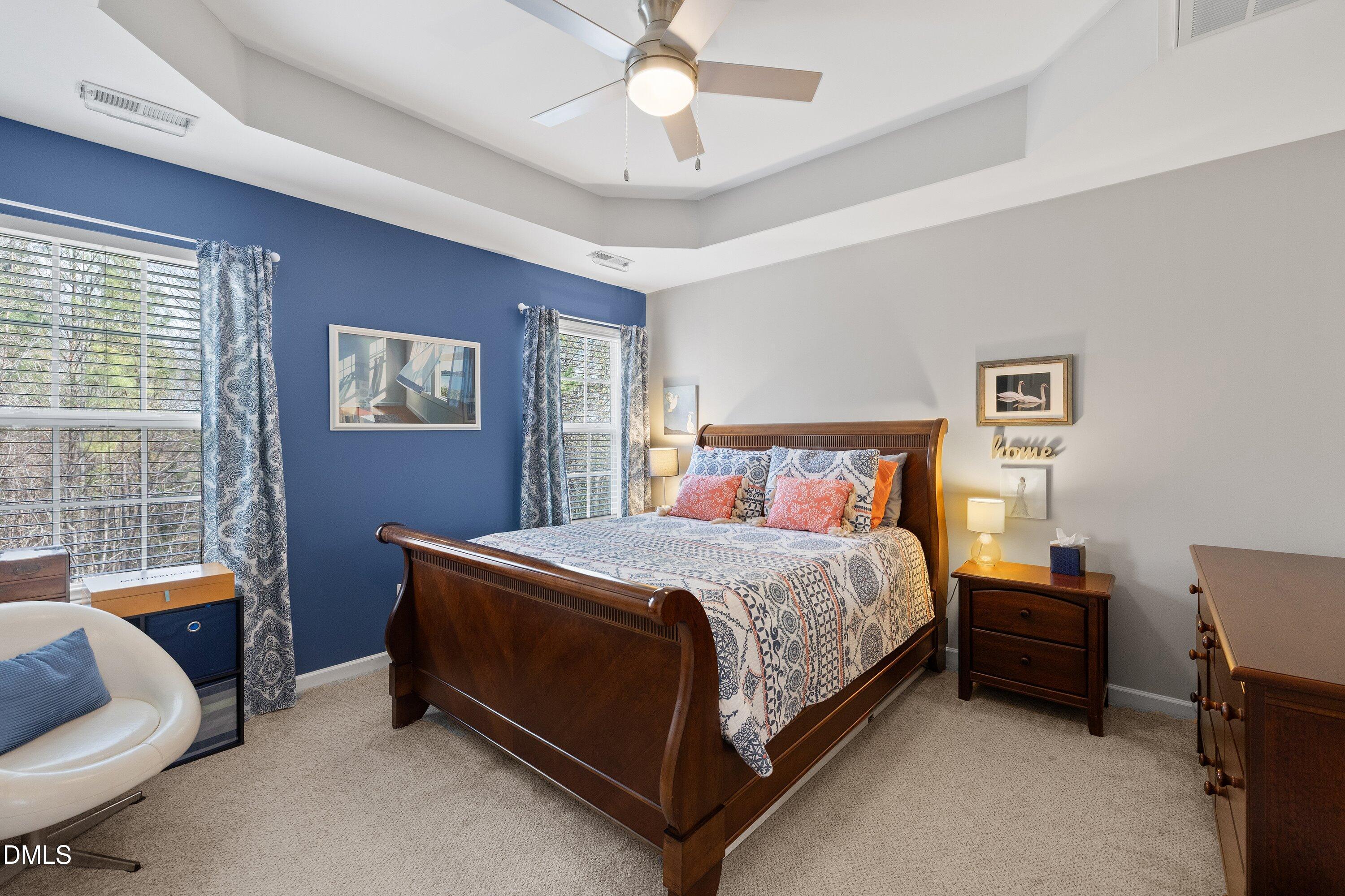 1093 Renewal Place Raleigh, NC 27603 - Photo 25 of 45 a bedroom with a bed and a chandelier