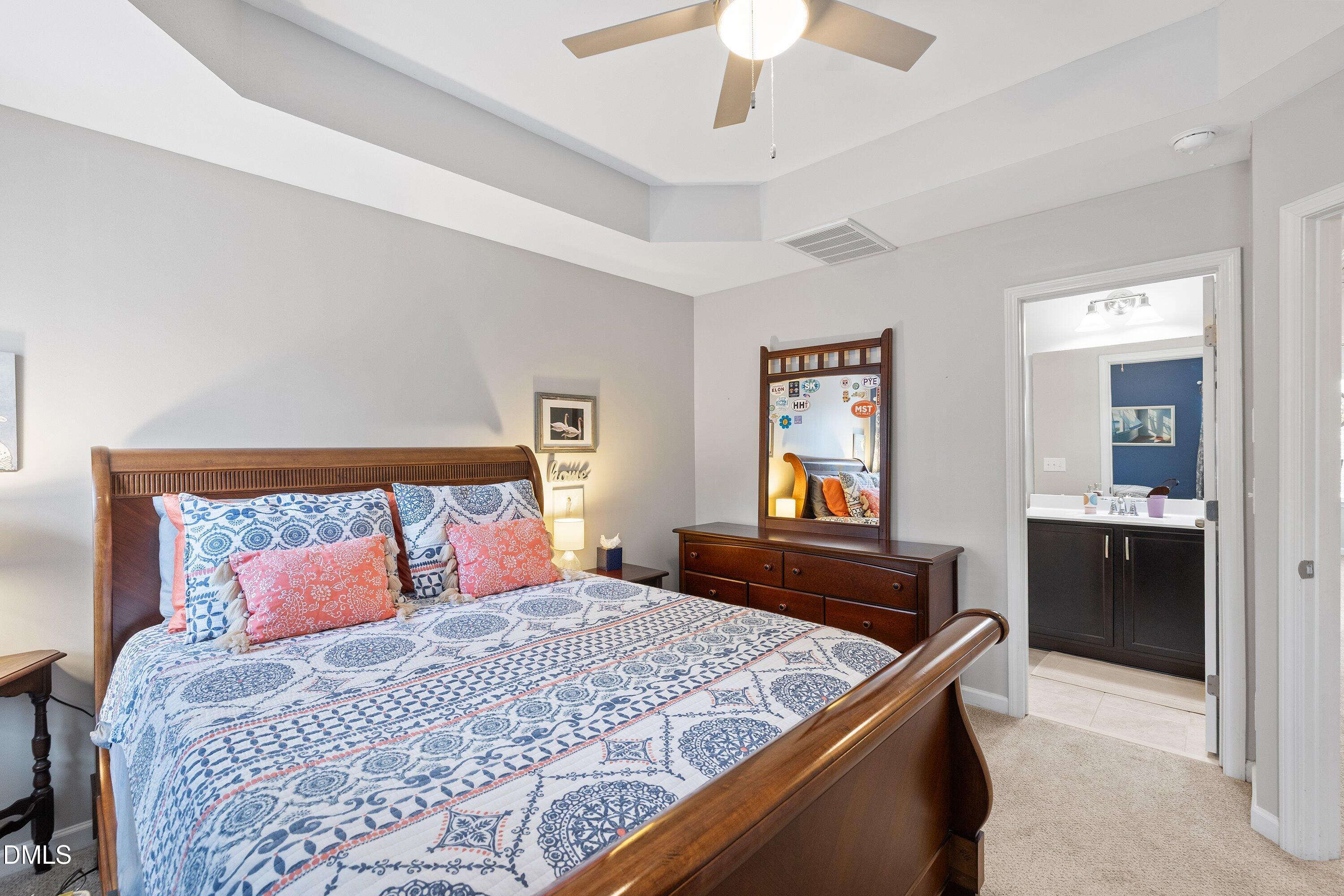 1093 Renewal Place Raleigh, NC 27603 - Photo 26 of 45 a bedroom with a large bed and a chandelier