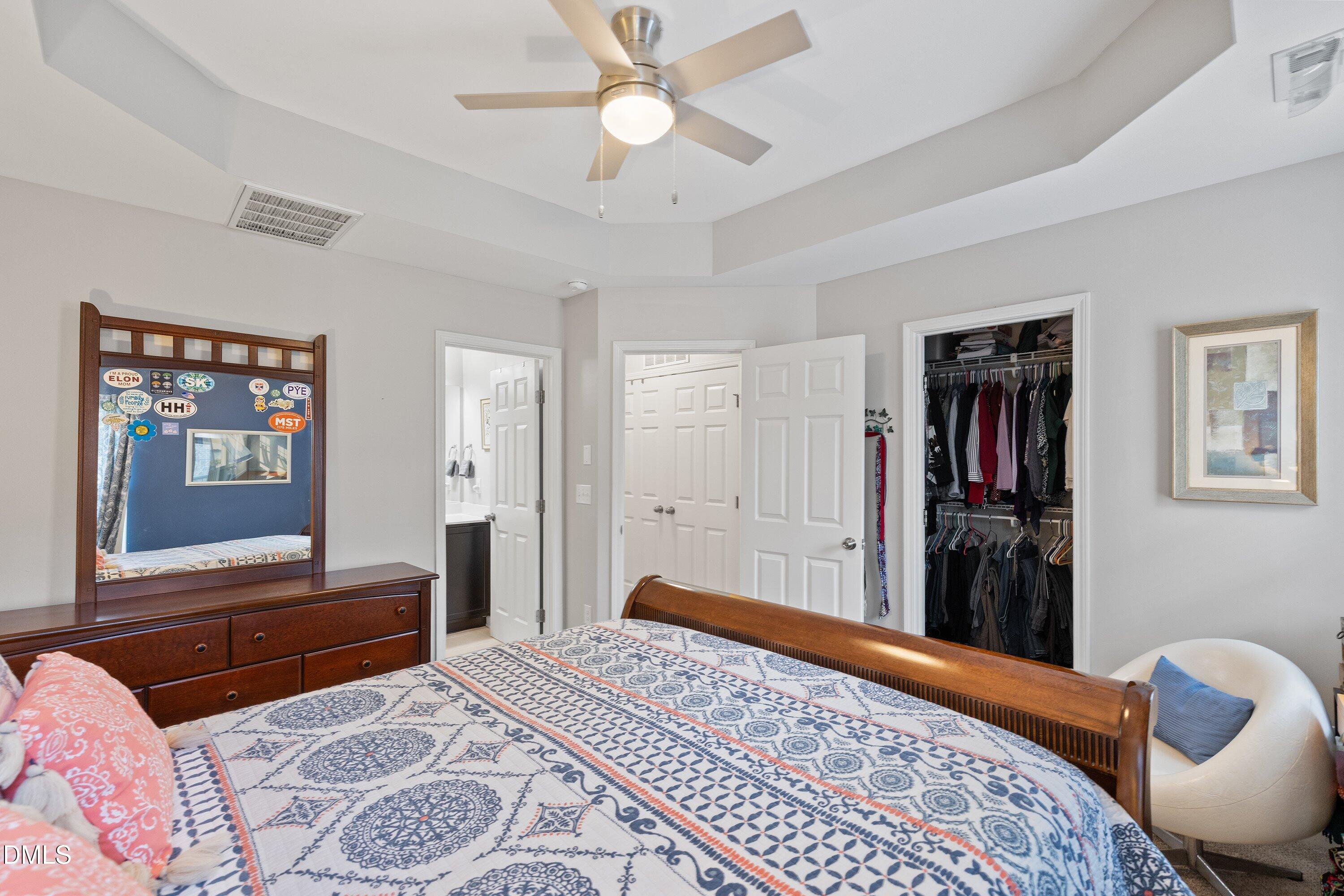 1093 Renewal Place Raleigh, NC 27603 - Photo 27 of 45 a bedroom with a bed and dresser with mirror
