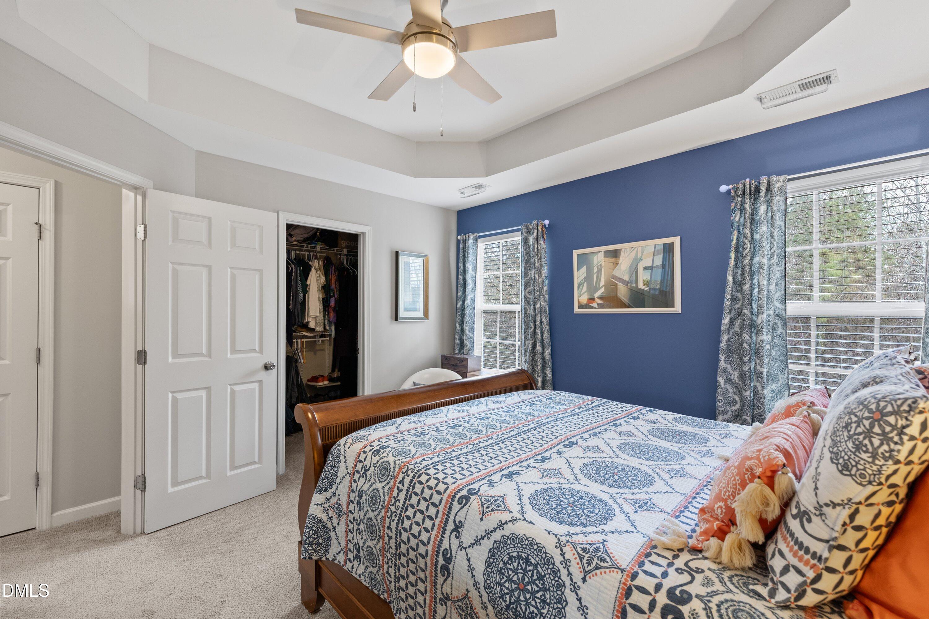 1093 Renewal Place Raleigh, NC 27603 - Photo 28 of 45 a bedroom with a large bed and a chandelier