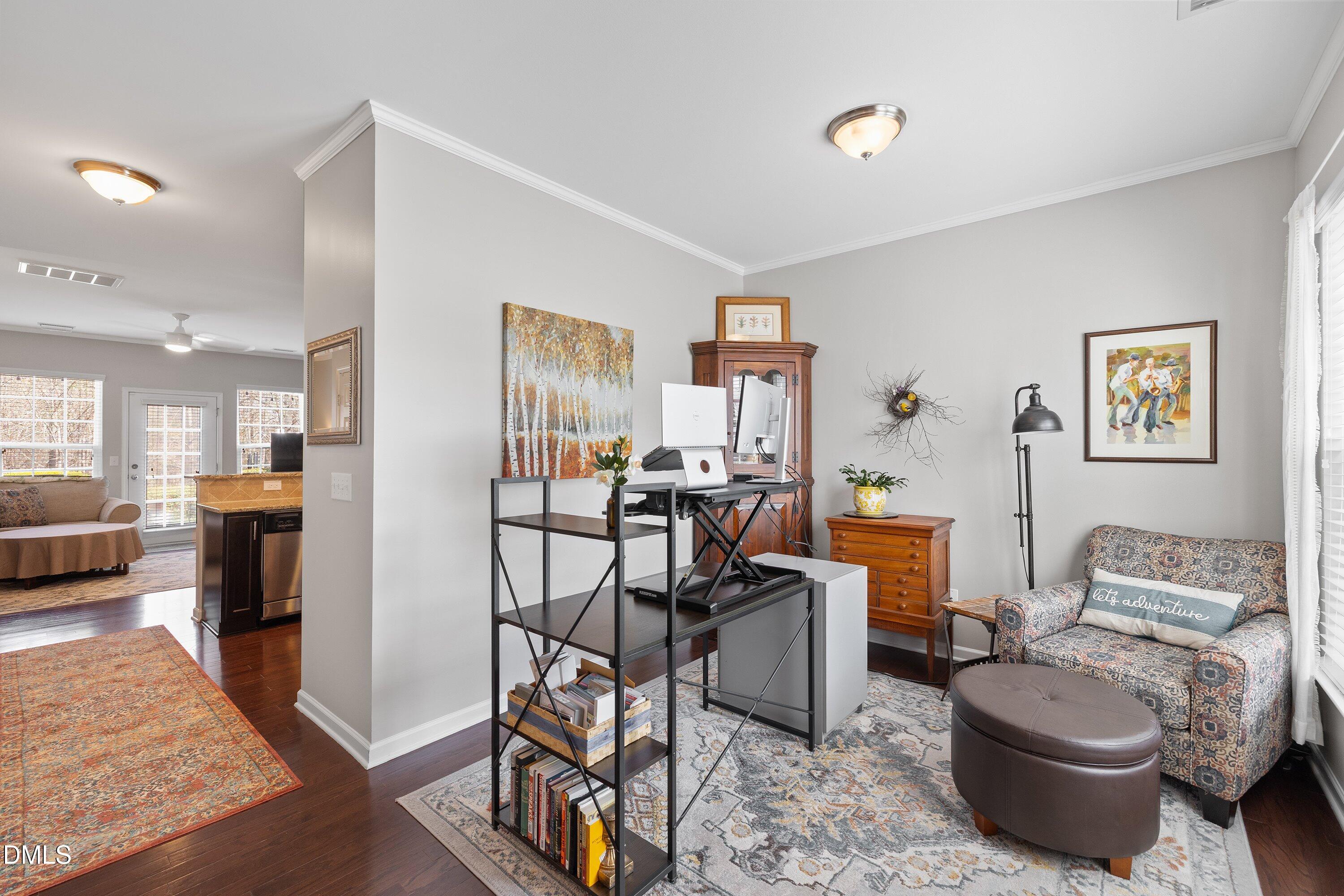 1093 Renewal Place Raleigh, NC 27603 - Photo 3 of 45 a living room with furniture a rug and kitchen view