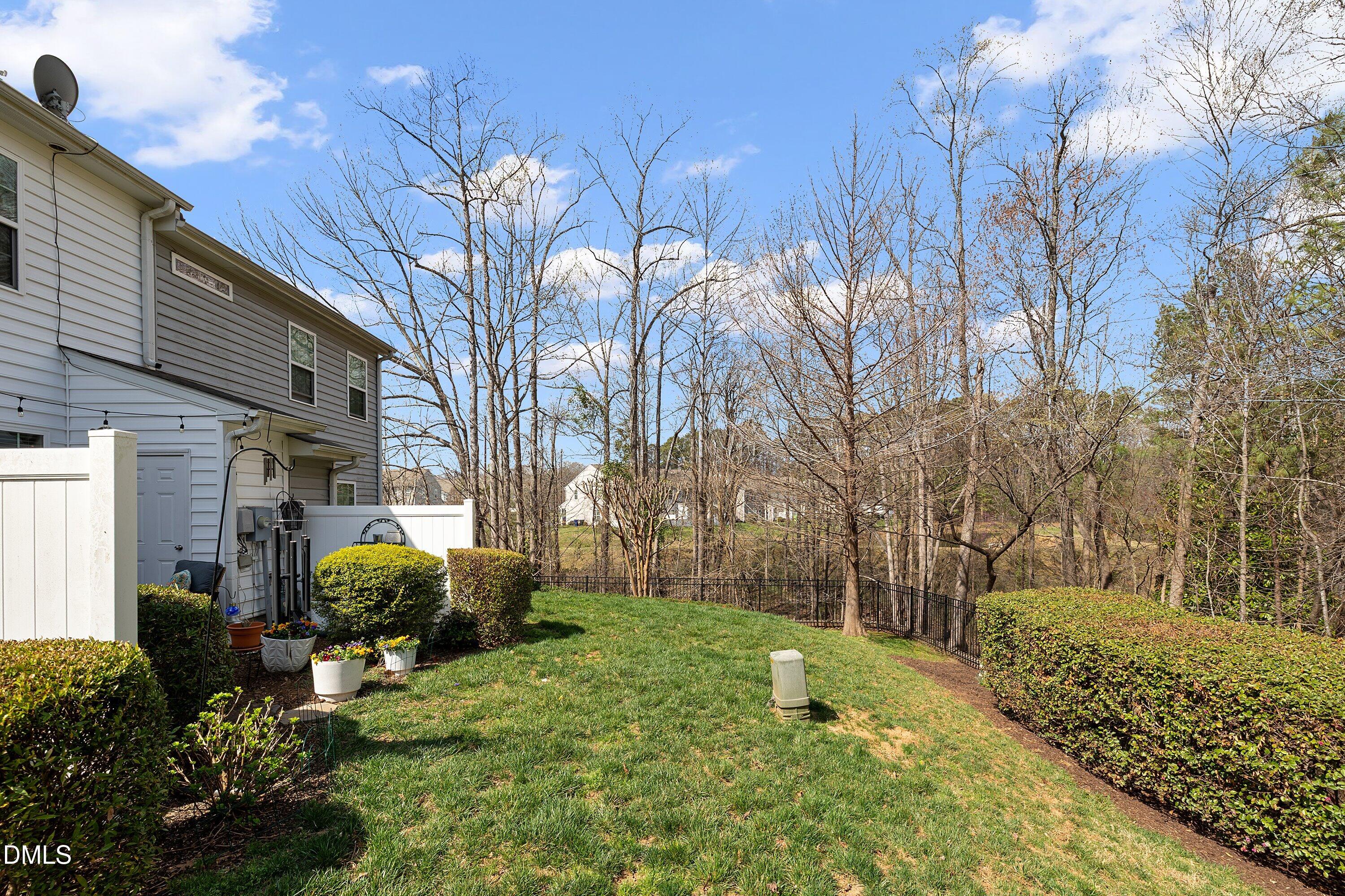 1093 Renewal Place Raleigh, NC 27603 - Photo 35 of 45 a view of a backyard with potted plants and large trees