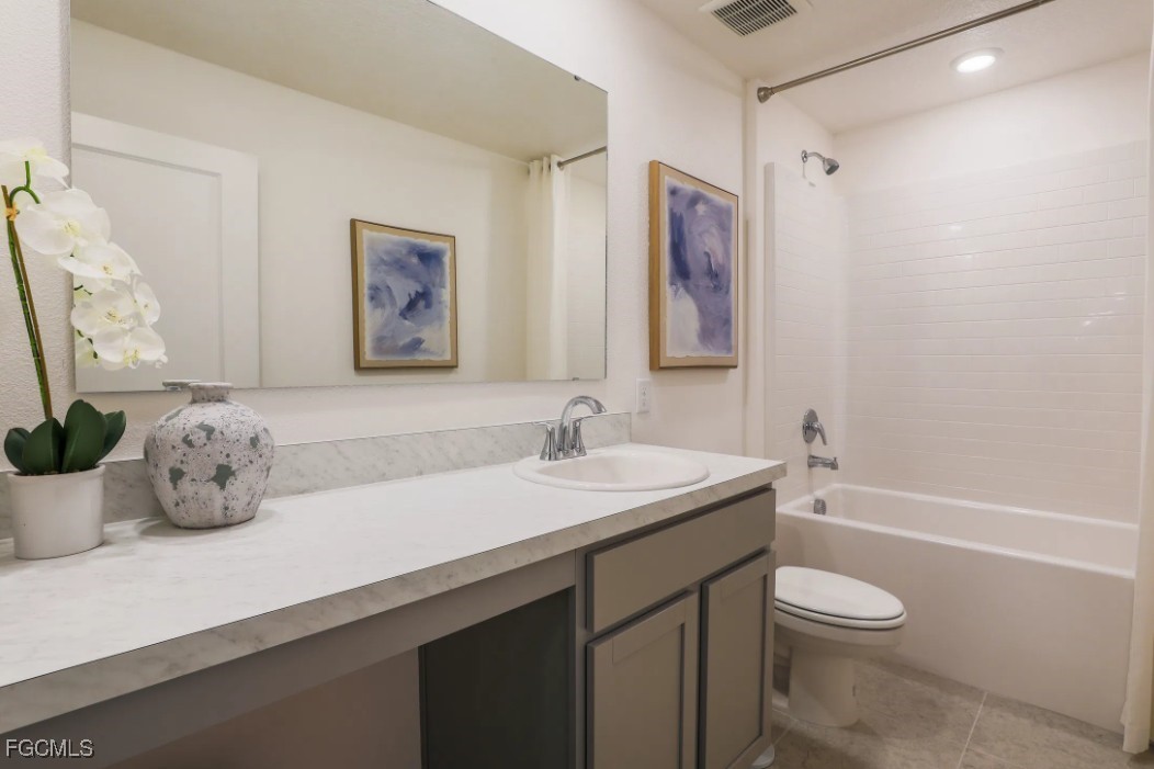 3505 32nd Street Southwest Lehigh Acres, FL 33976 - Photo 9 of 11 a bathroom with a granite countertop sink a toilet and a bathtub