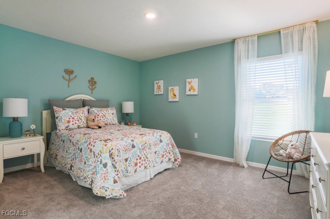 3505 32nd Street Southwest Lehigh Acres, FL 33976 - Photo 10 of 11 a bedroom with a bed and a window