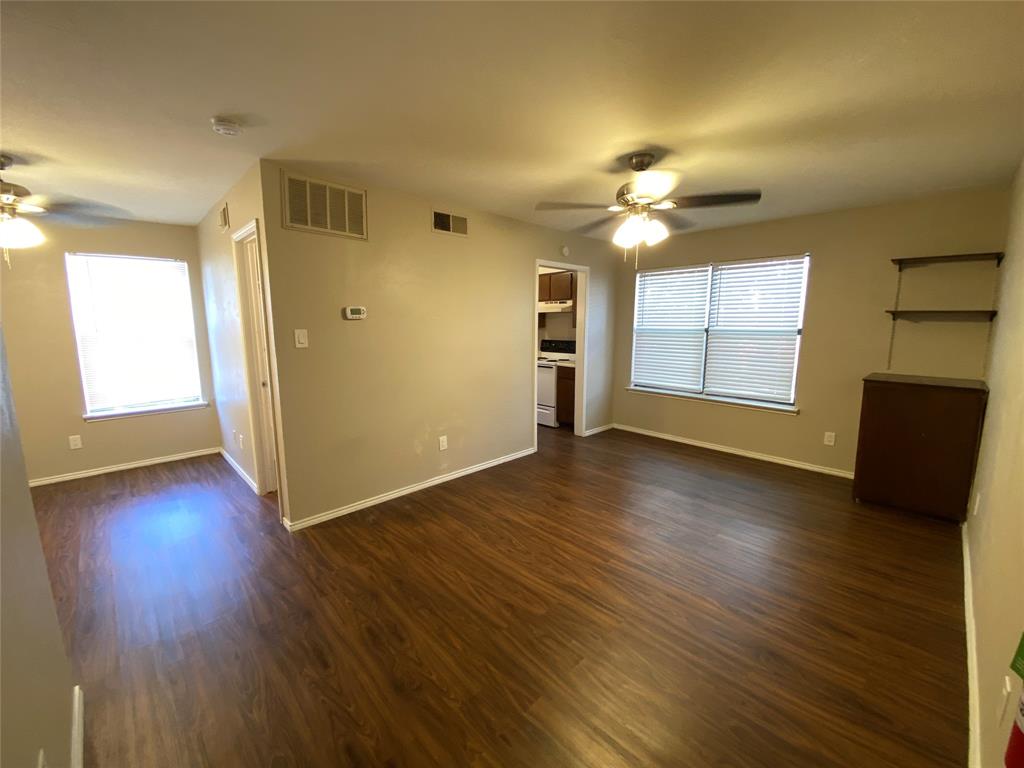 a view of a livingroom with a hardwood floor and a ceiling fan