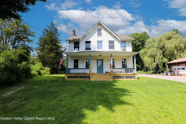 a view of a house with a yard porch and sitting area