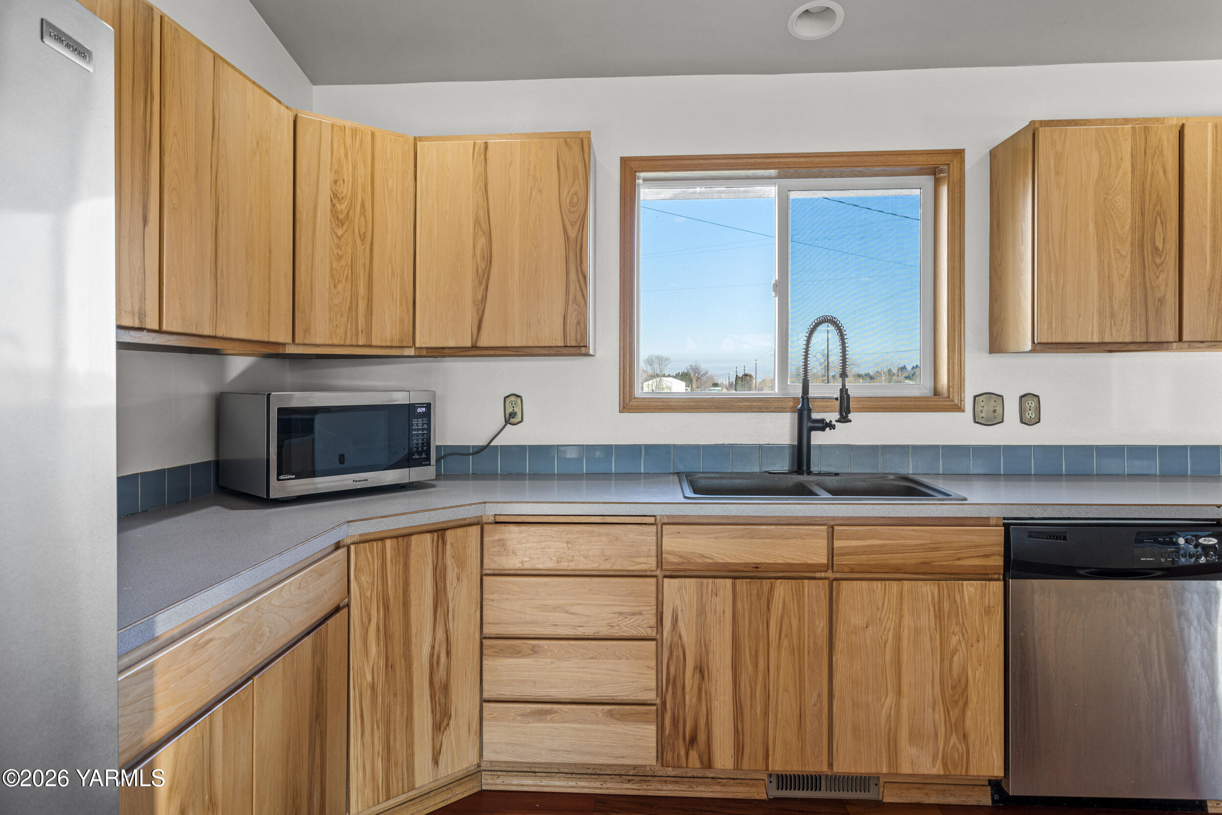 14929 Cottonwood Canyon Road Yakima, WA 98908 - Photo 14 of 55 a kitchen with granite countertop a sink and cabinets