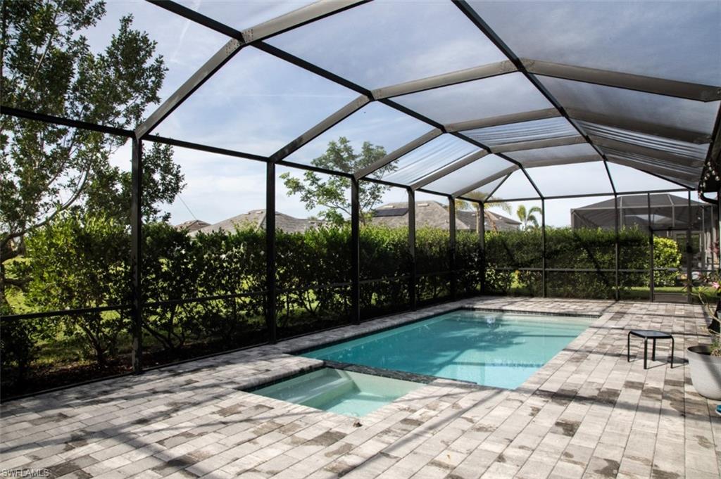 11726 Canopy Loop Fort Myers, FL 33913 - Photo 26 of 40 View of pool with a lanai, a sunroom, a pool with connected hot tub, and a patio area