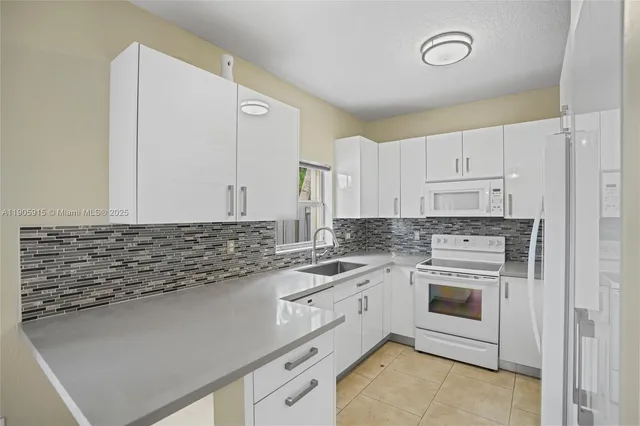 a kitchen with a sink stove and cabinets