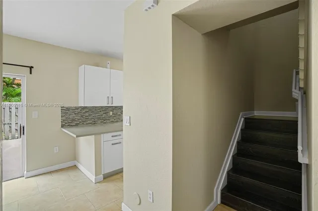 a room with a bench and hallway