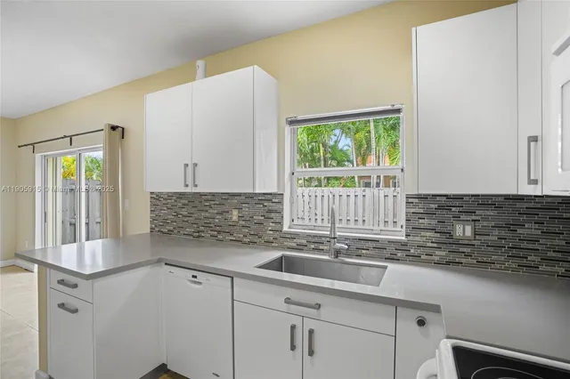 a kitchen with a sink and a window