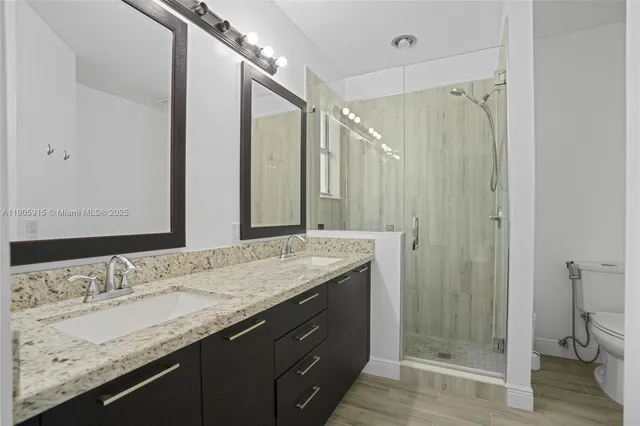 a bathroom with a granite countertop sink and a mirror