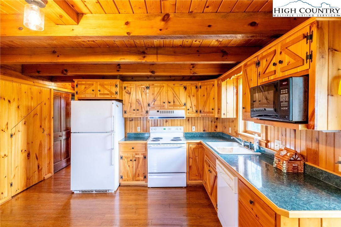 45 Bailey Road Ennice, NC 28623 - Photo 12 of 48 a kitchen with stainless steel appliances granite countertop a sink a stove and a wooden floors