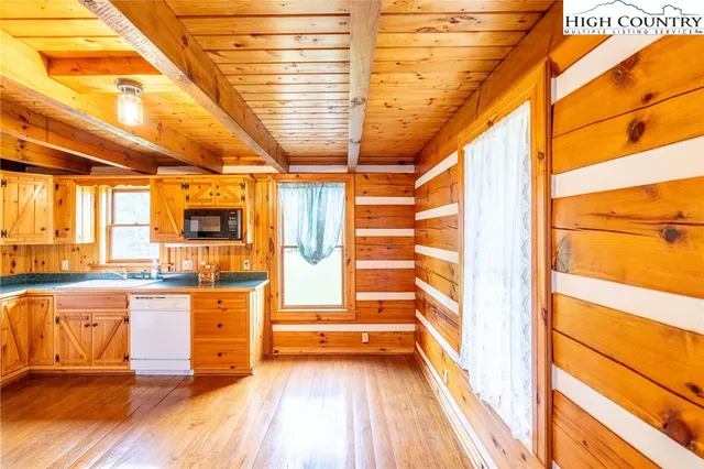 a view of a kitchen with a sink and cabinets