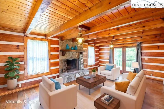 a living room with furniture a fireplace and a table