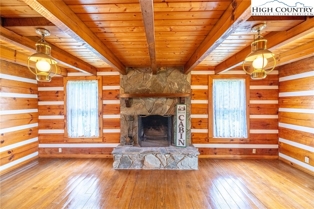 45 Bailey Road Ennice, NC 28623 - Photo 26 of 48 a view of livingroom with wooden floor and a fireplace