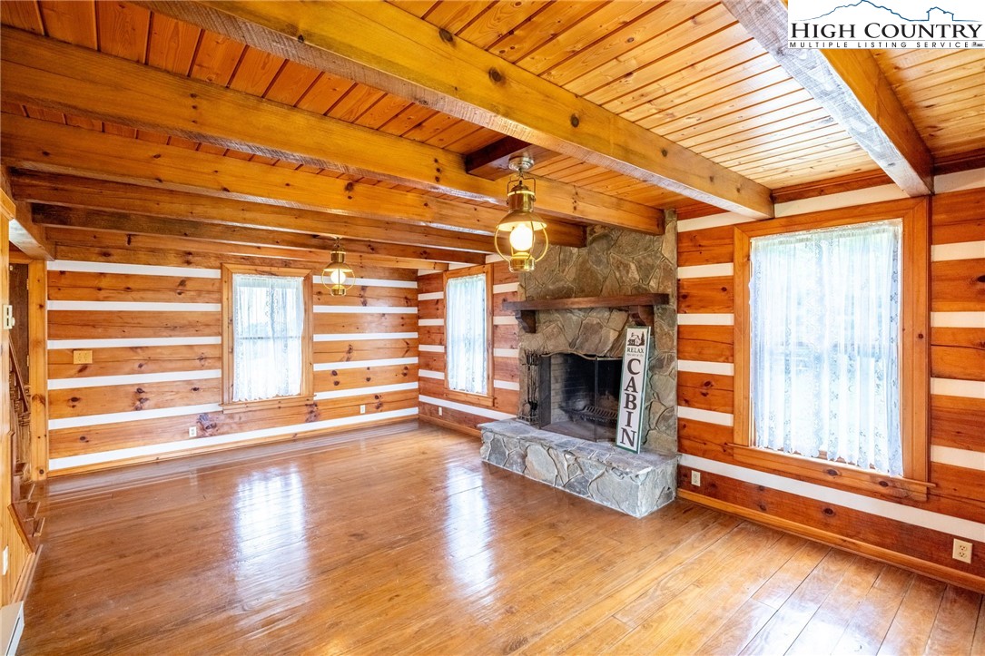 45 Bailey Road Ennice, NC 28623 - Photo 28 of 48 a view of empty room with wooden floor and fireplace