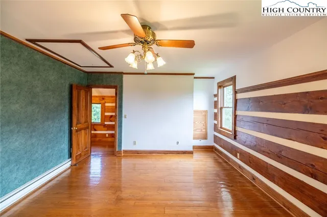 a view of room with window and wooden floor