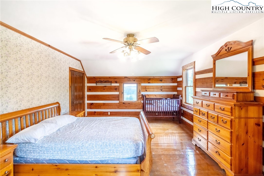 45 Bailey Road Ennice, NC 28623 - Photo 42 of 48 a bedroom with a bed and wooden floor
