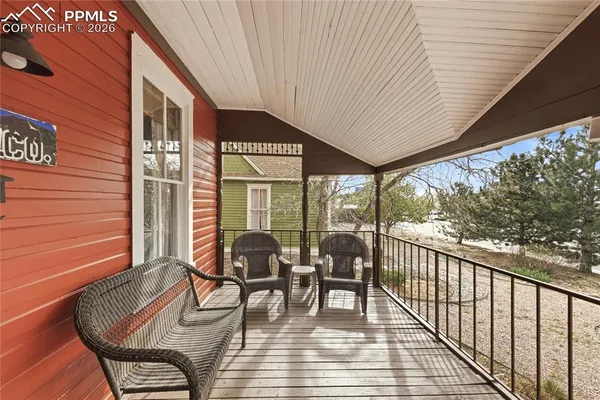 a view of a chairs and table in the balcony