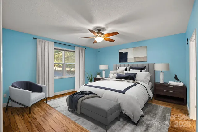 a bedroom with bed and a chandelier