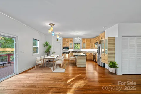 a living room with furniture dining table and a potted plant