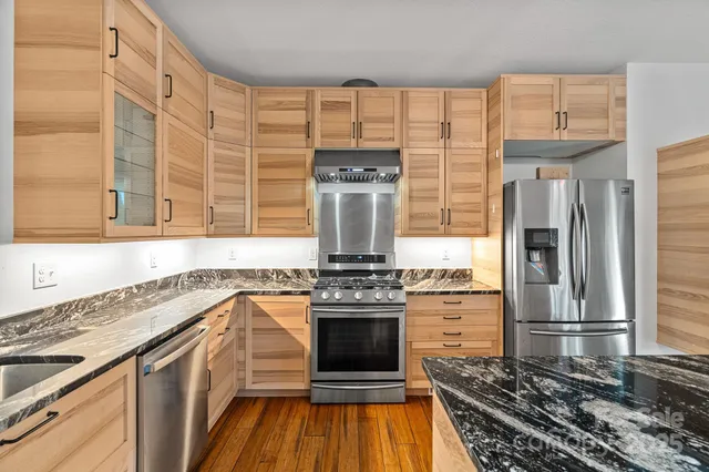a kitchen with a stove and a refrigerator