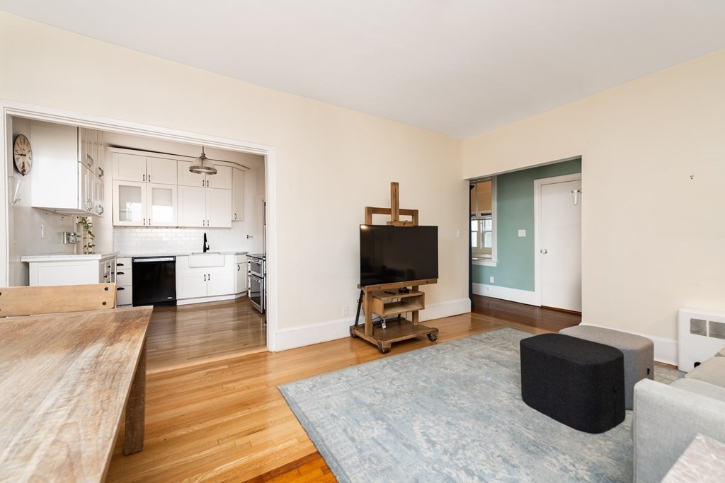 21 Warwick Road, Unit 4 Brookline, MA 02445 - Photo 3 of 11 a living room with furniture and a flat screen tv