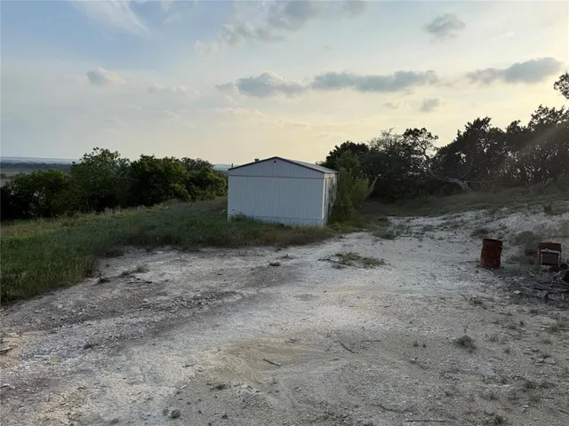 a view of a house with a backyard