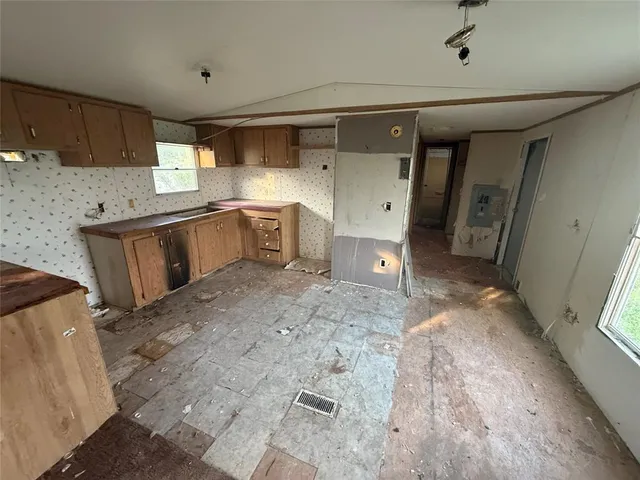 an empty room with windows and closet