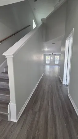 a view of a kitchen and wooden floor