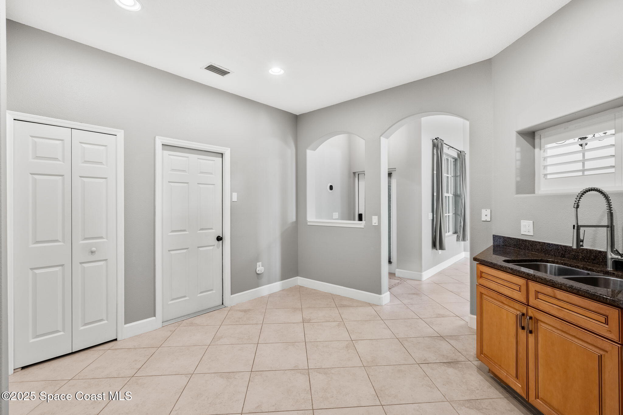 3126 Arden Circle Melbourne, FL 32934 - Photo 12 of 33 a view of a sink and a refrigerator in a kitchen