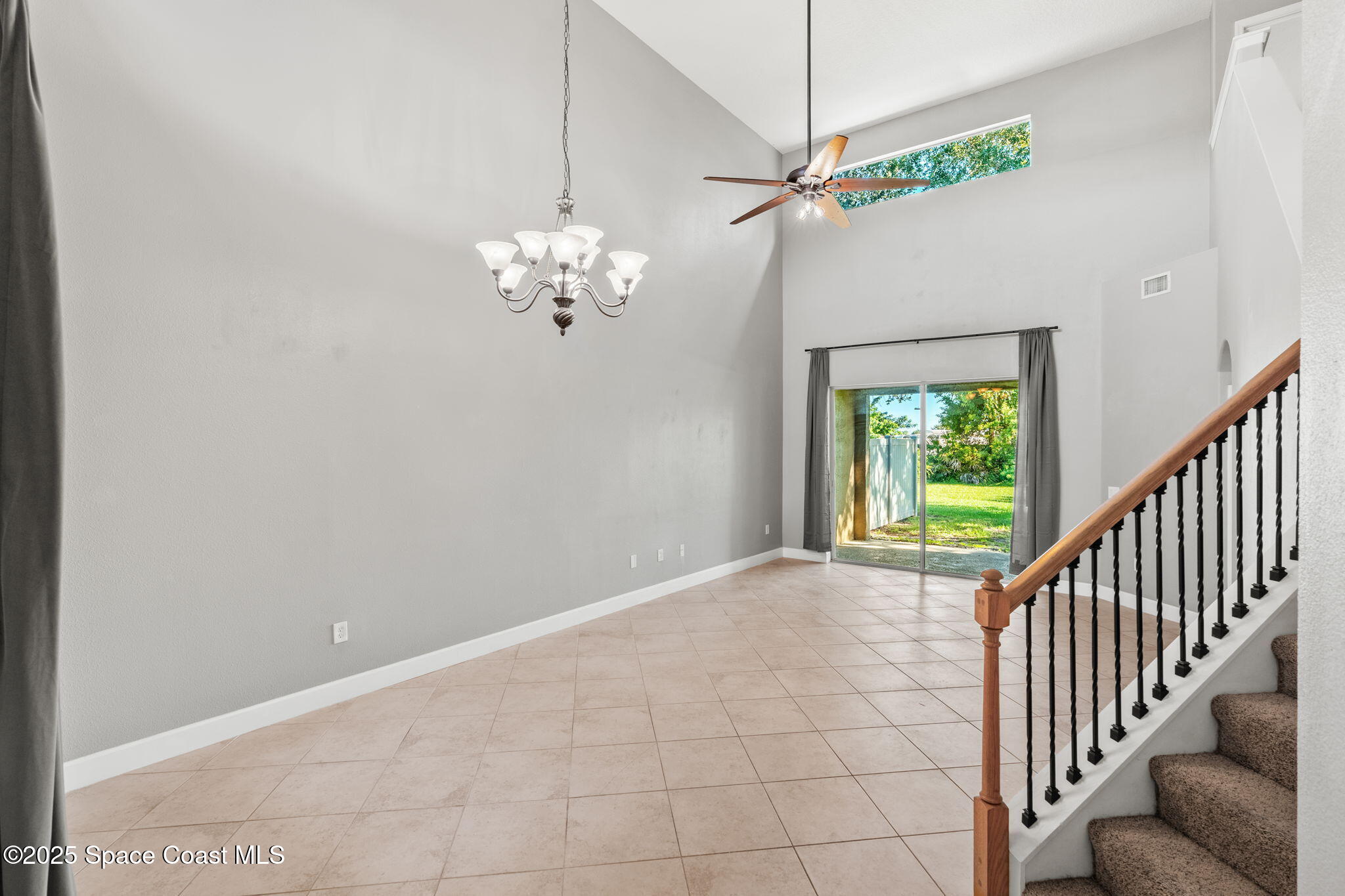 3126 Arden Circle Melbourne, FL 32934 - Photo 14 of 33 a view of an empty room with a chandelier fan