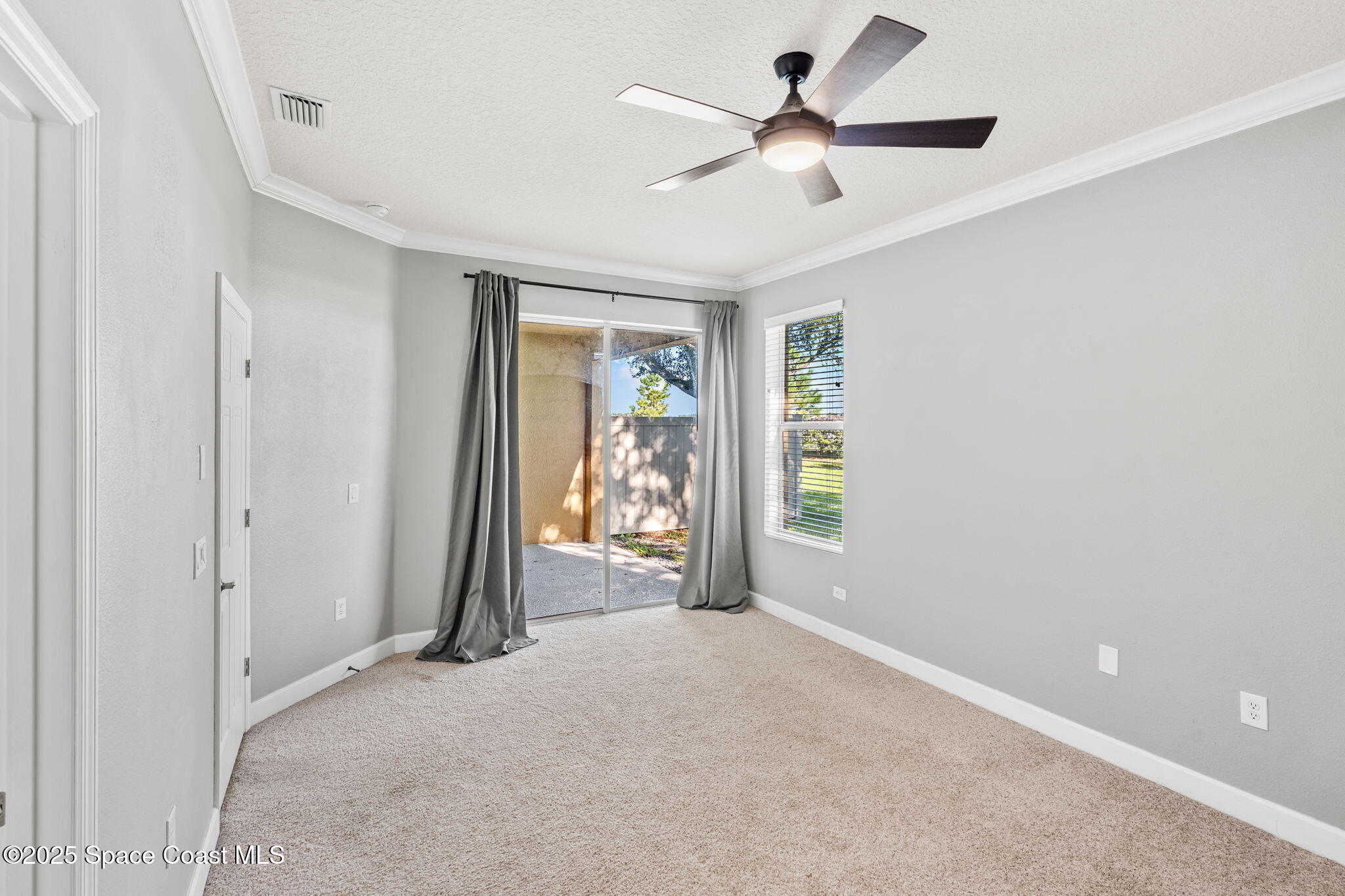 3126 Arden Circle Melbourne, FL 32934 - Photo 16 of 33 a view of a livingroom with a ceiling fan and window