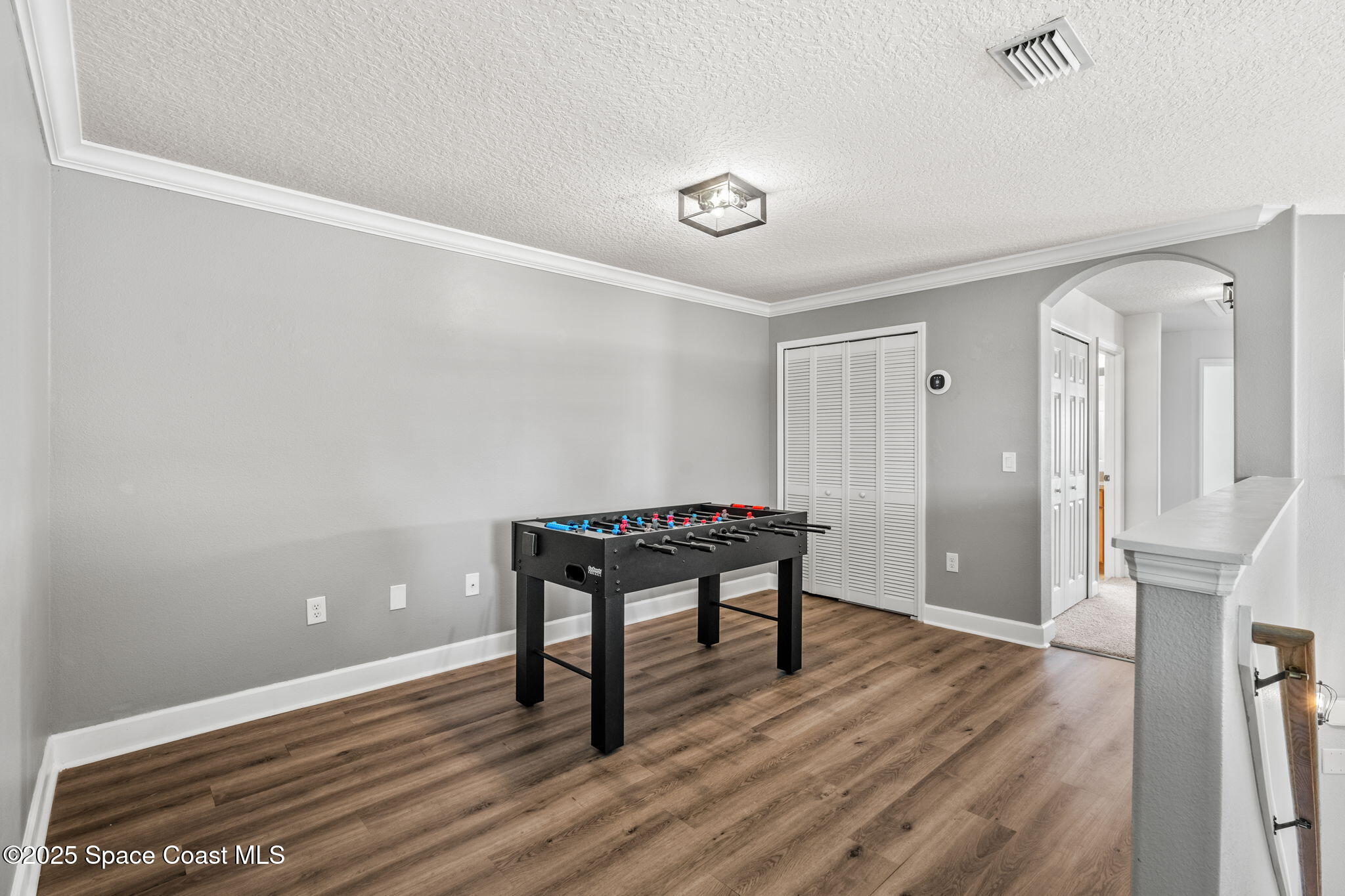 3126 Arden Circle Melbourne, FL 32934 - Photo 18 of 33 a view of a room with wooden floor and a rug