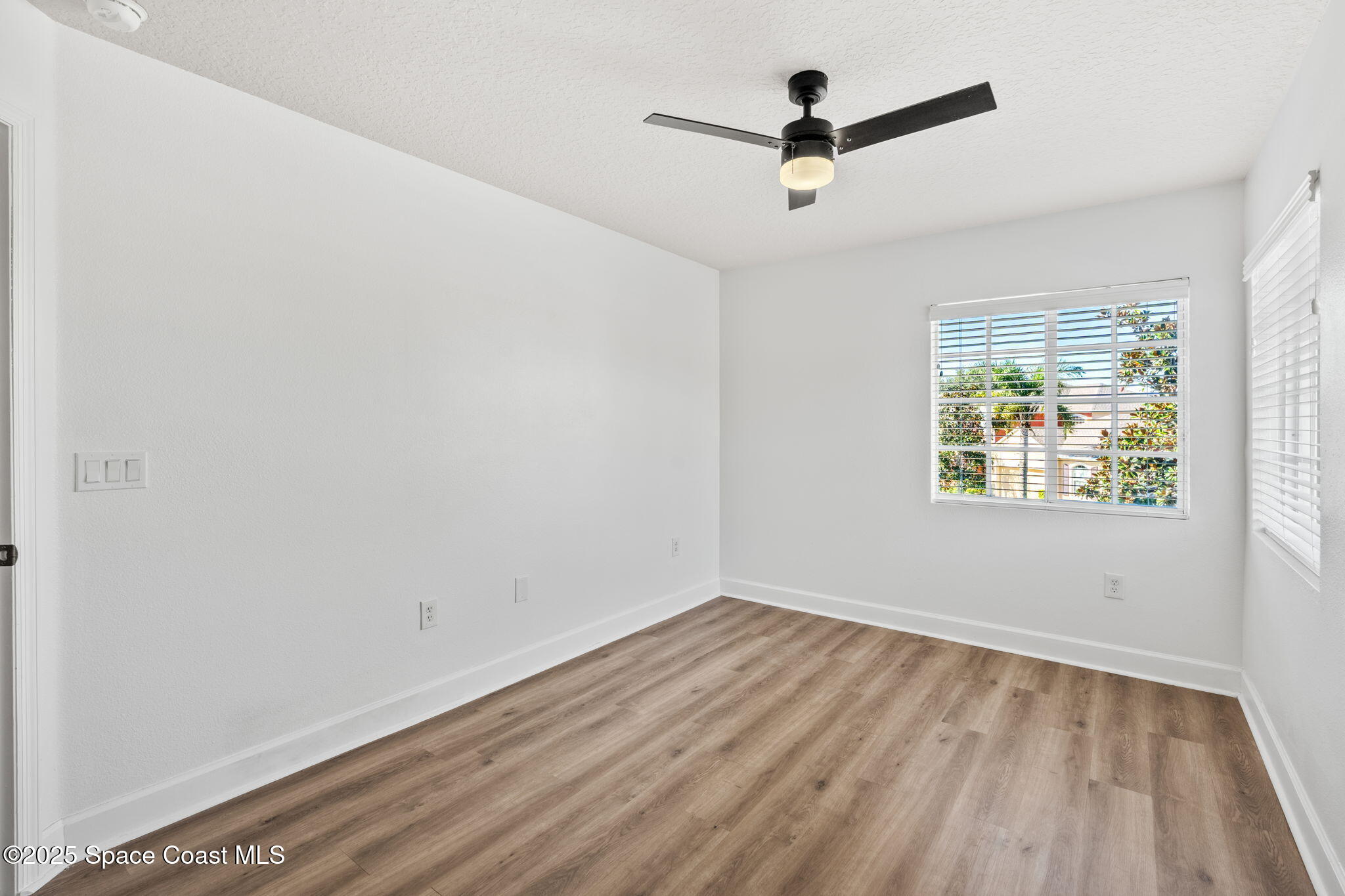 3126 Arden Circle Melbourne, FL 32934 - Photo 20 of 33 wooden floor in an empty room with a window