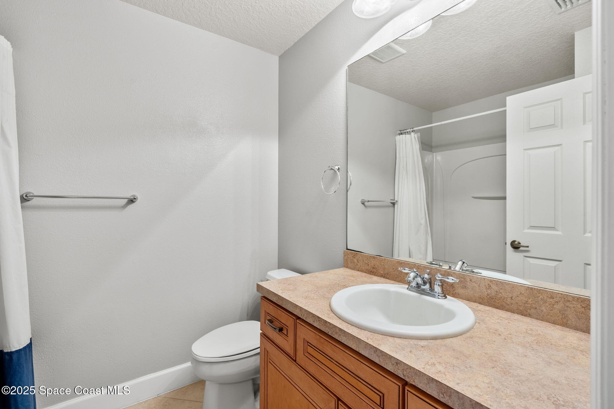 3126 Arden Circle Melbourne, FL 32934 - Photo 21 of 33 a bathroom with a granite countertop sink toilet and a mirror