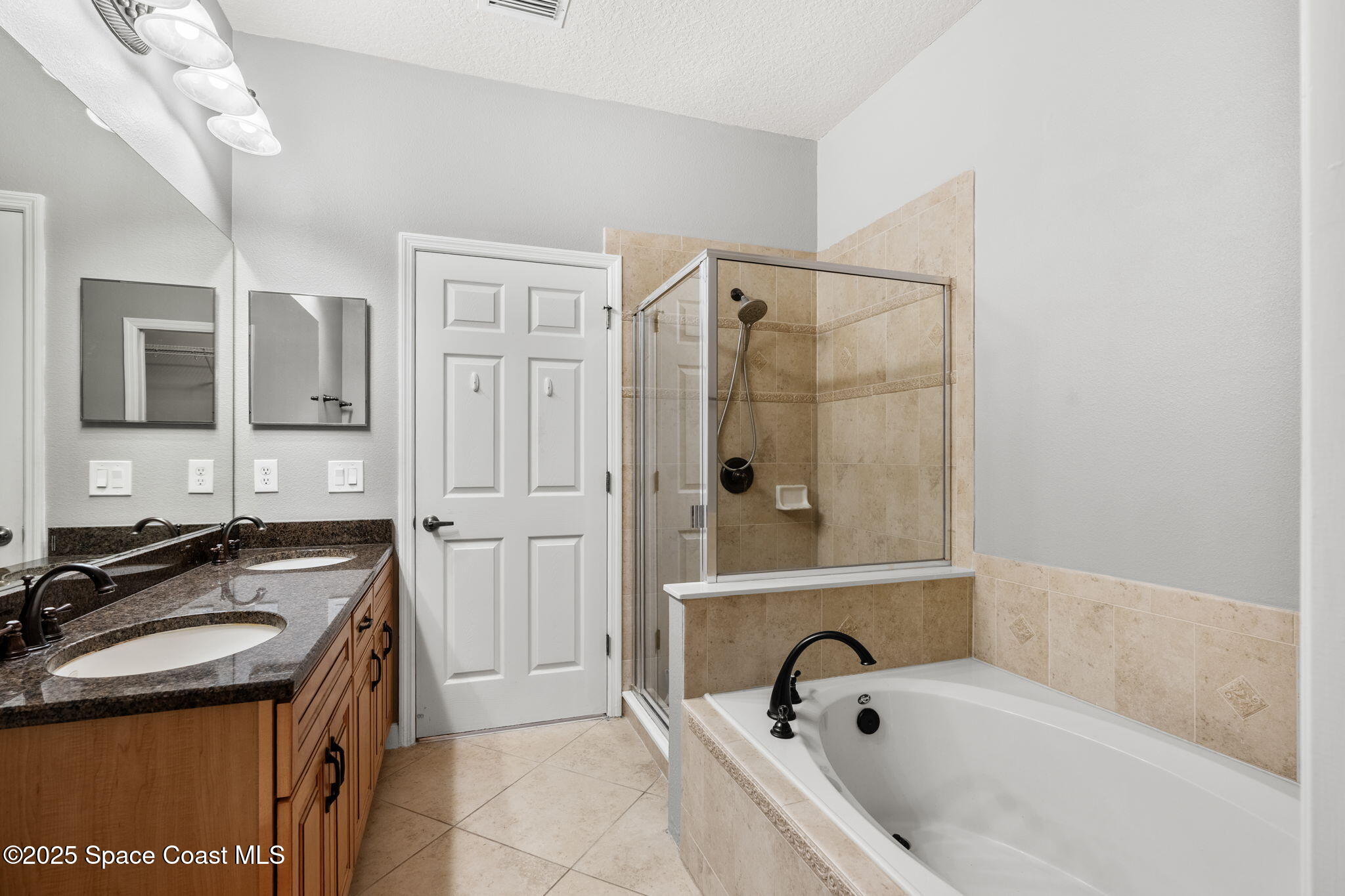 3126 Arden Circle Melbourne, FL 32934 - Photo 26 of 33 a bathroom with a granite countertop tub sink and mirror