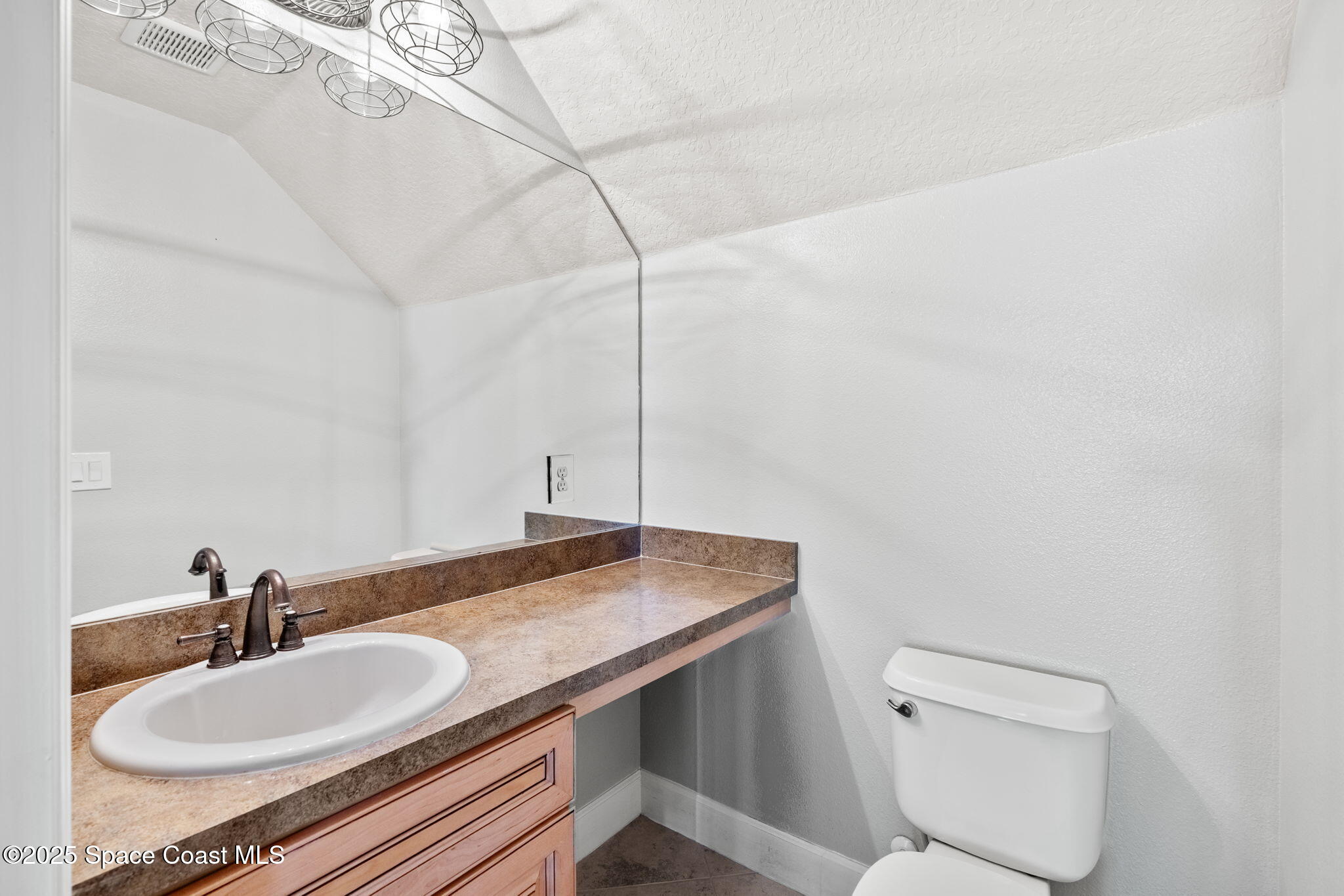 3126 Arden Circle Melbourne, FL 32934 - Photo 28 of 33 a bathroom with a sink and a toilet