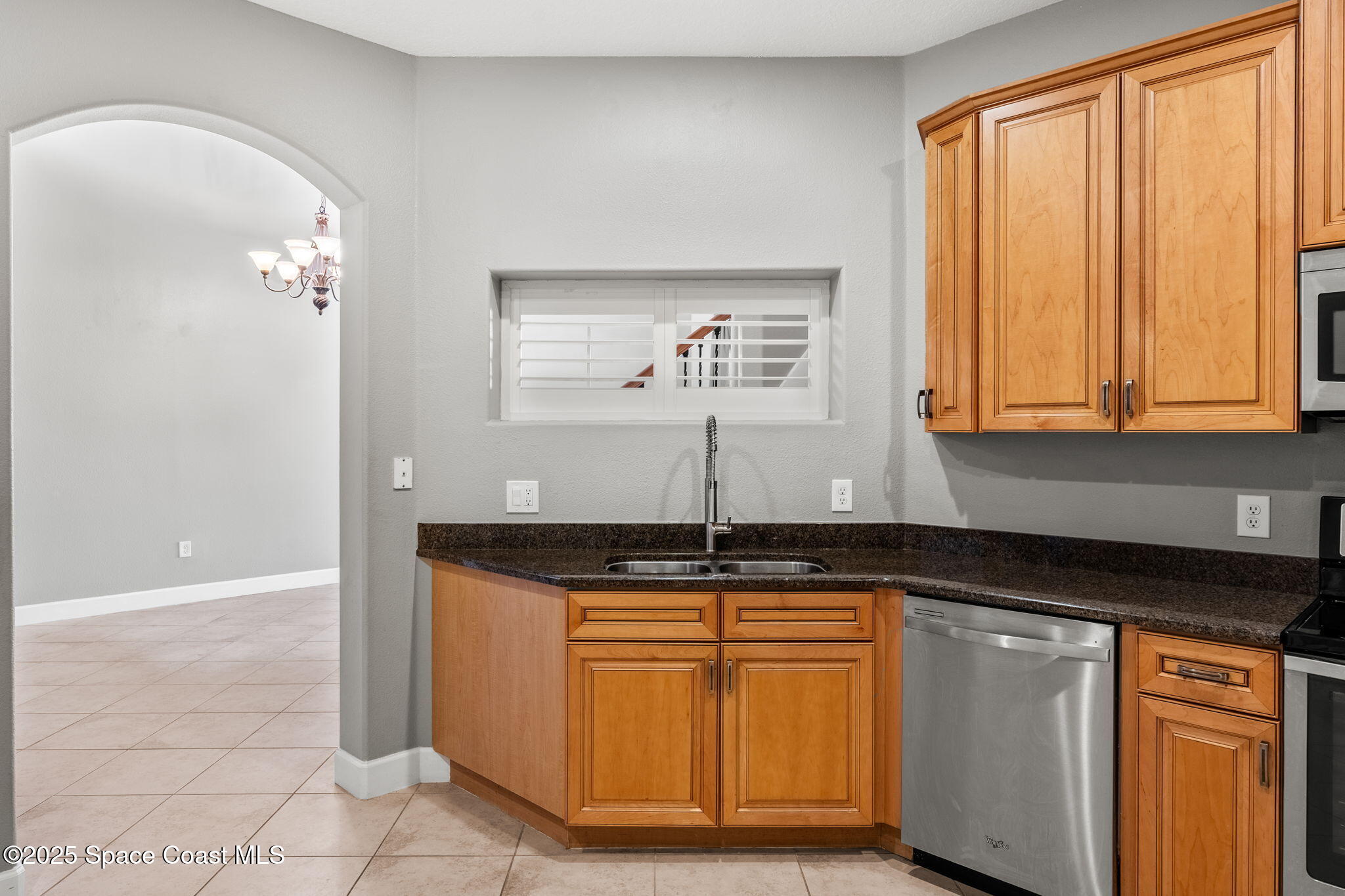 3126 Arden Circle Melbourne, FL 32934 - Photo 9 of 33 a kitchen with granite countertop a sink stainless steel appliances and cabinets
