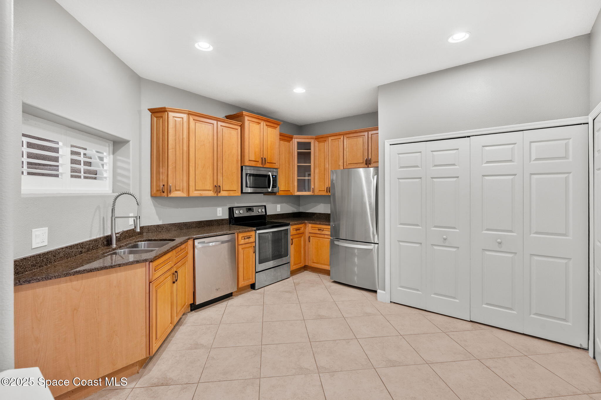 3126 Arden Circle Melbourne, FL 32934 - Photo 10 of 33 a kitchen with stainless steel appliances granite countertop a refrigerator and a sink