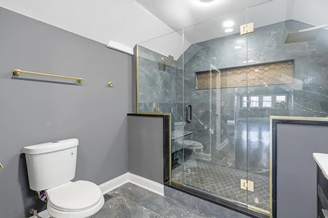 a white toilet sitting next to a bathroom sink