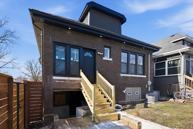 a front view of a house with large windows