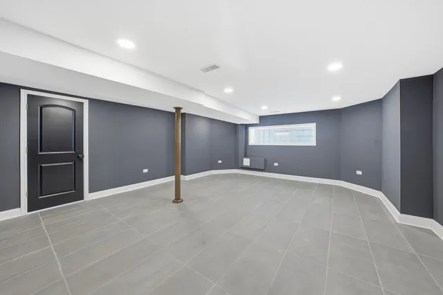 a bathroom with a toilet a sink a vanity and mirror