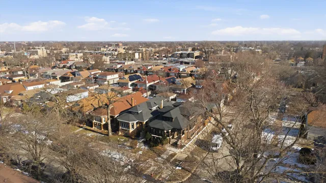 an aerial view of residential houses with city view