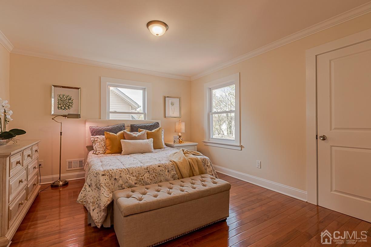 150 New Market Road Dunellen, NJ 08812 - Photo 12 of 22 a bedroom with a bed and wooden floor