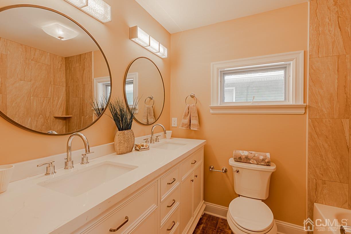 150 New Market Road Dunellen, NJ 08812 - Photo 14 of 22 a bathroom with a granite countertop toilet sink and mirror