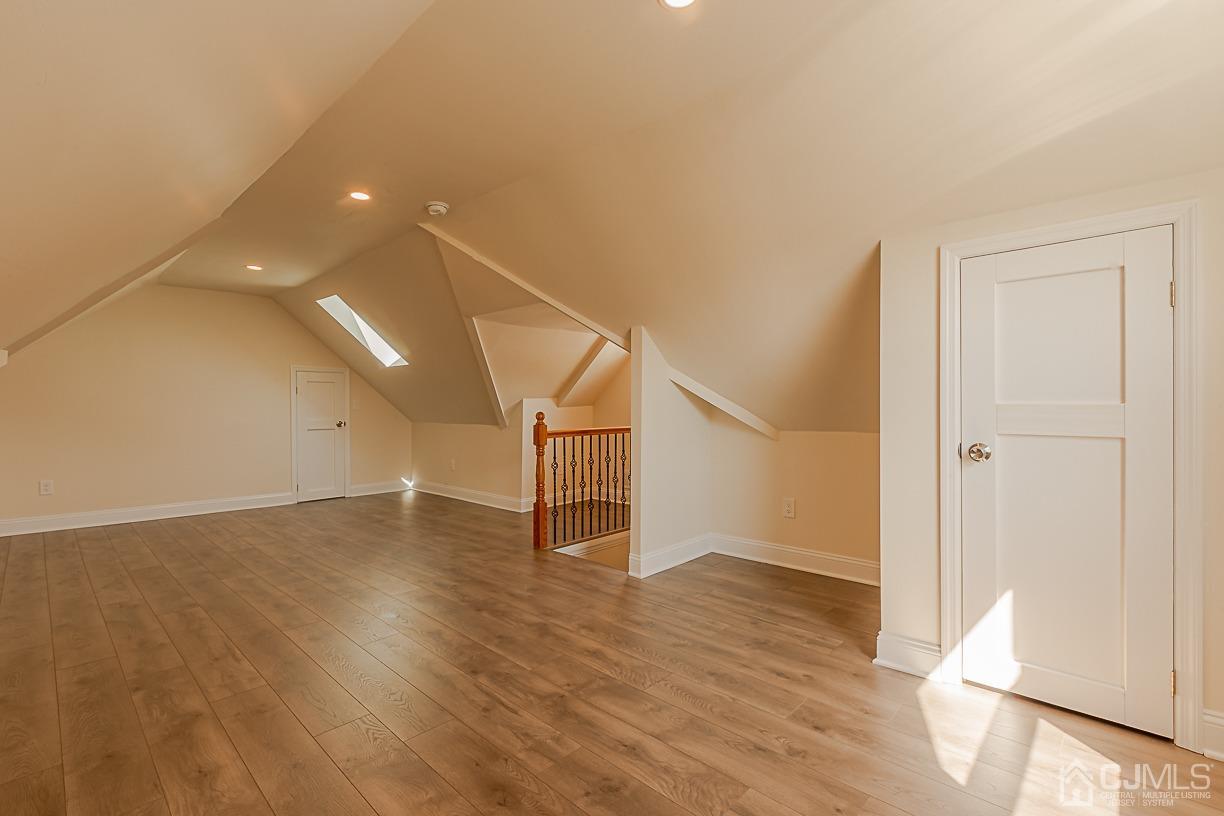 150 New Market Road Dunellen, NJ 08812 - Photo 19 of 22 an empty room with wooden floor and windows