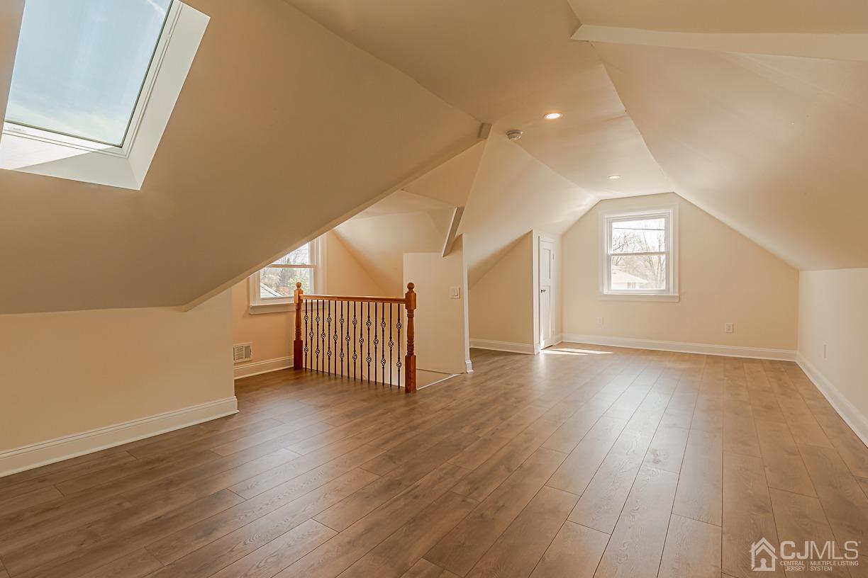 150 New Market Road Dunellen, NJ 08812 - Photo 20 of 22 a view of a hallway with wooden floor and windows